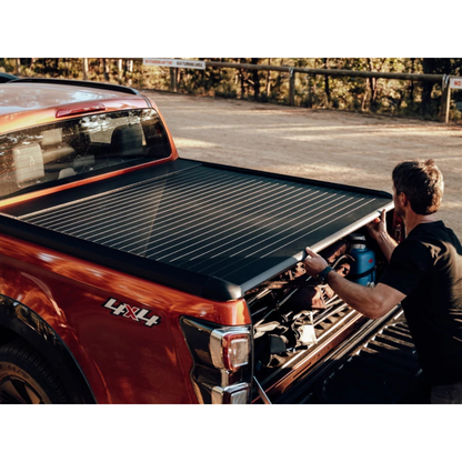 Couvre-benne manuel Mountain Top EVOm pour Mitsubishi L200 2019+ Double Cab, en tissu robuste, installé sur la benne du véhicule.